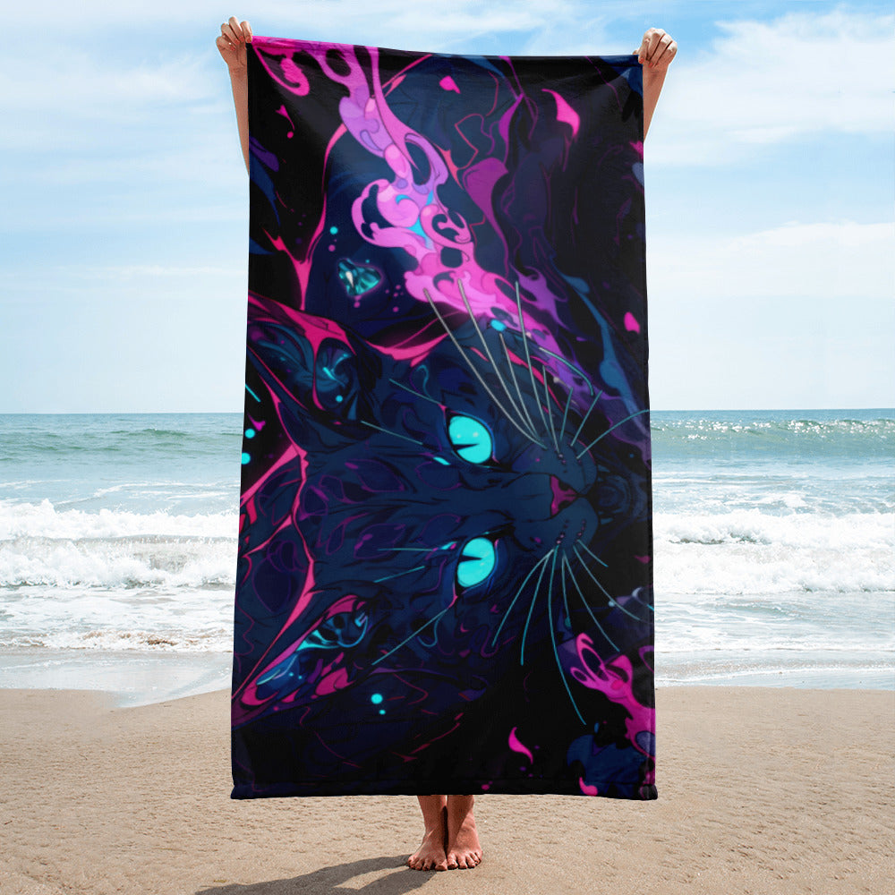 Person holding a colorful towel with abstract design on a beach